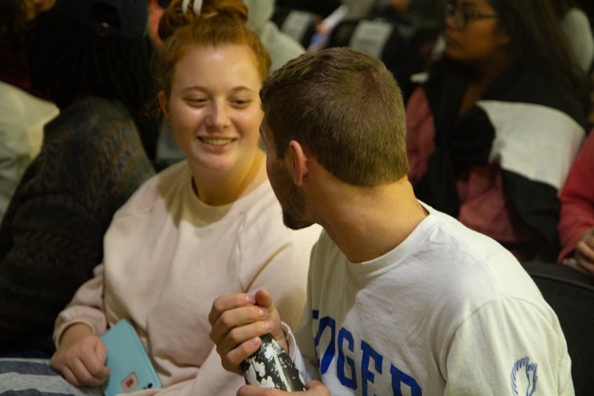 Audience members smiling.