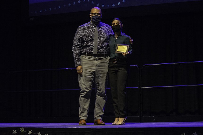 Student poses with award 