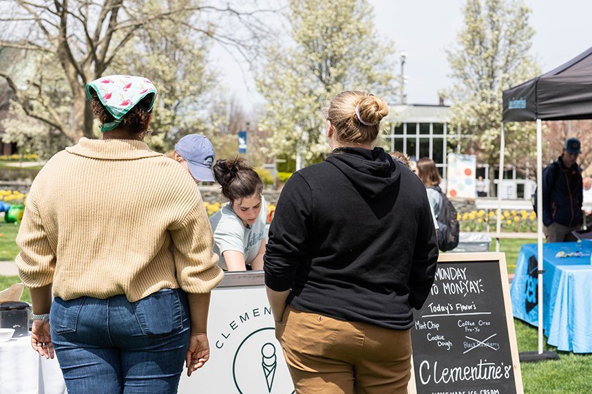 Two students wait to order at an ice cream cart. 