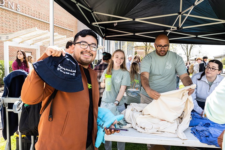 Students and staff at the CEN table handing out t-shirts. 