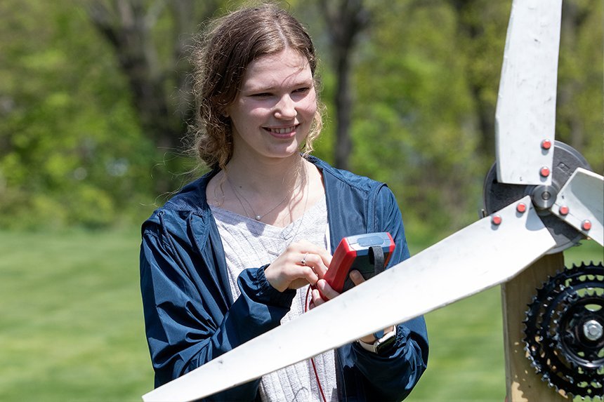 An Engineering student using the wind turbine 