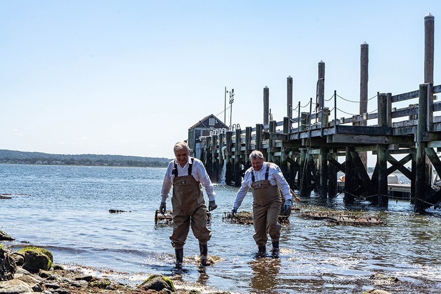 Senator Reed and President Miaoulis wade into shore.