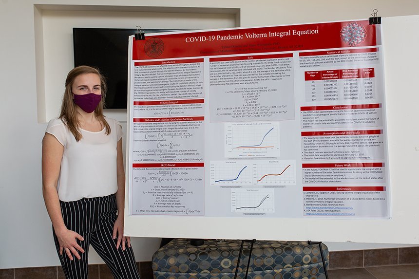 Student poses with poster