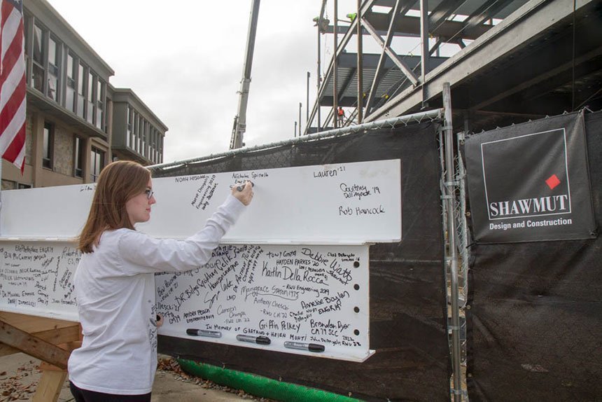 Student signs the beam.