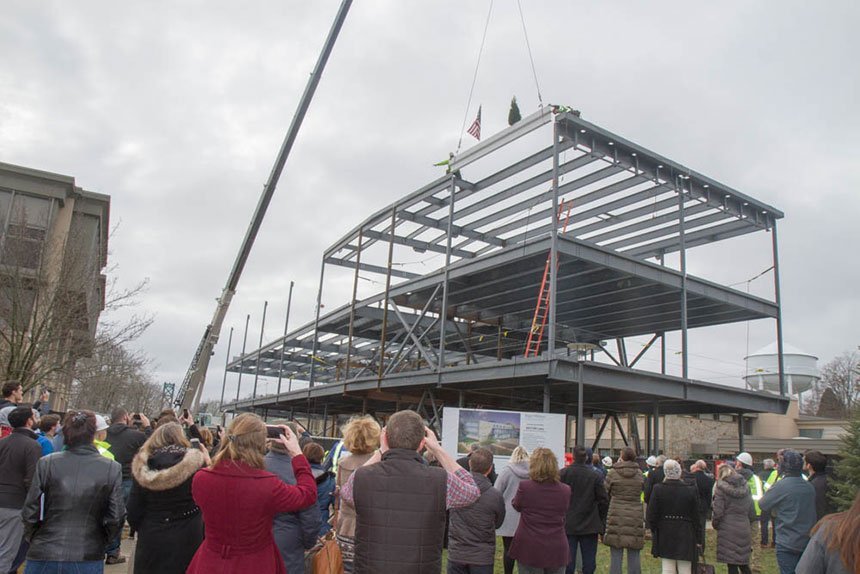 Beam gets raised into place atop the structure.