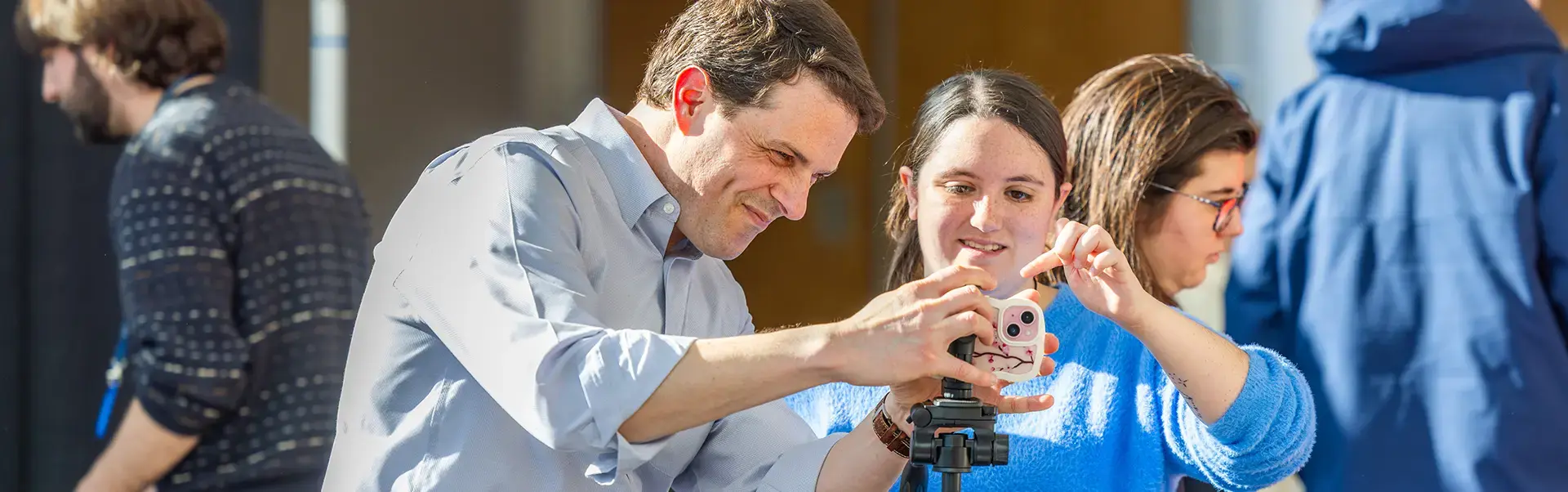 Professor works with student on communications project
